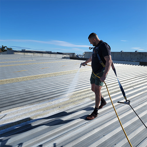 lsm man spraying gray roof